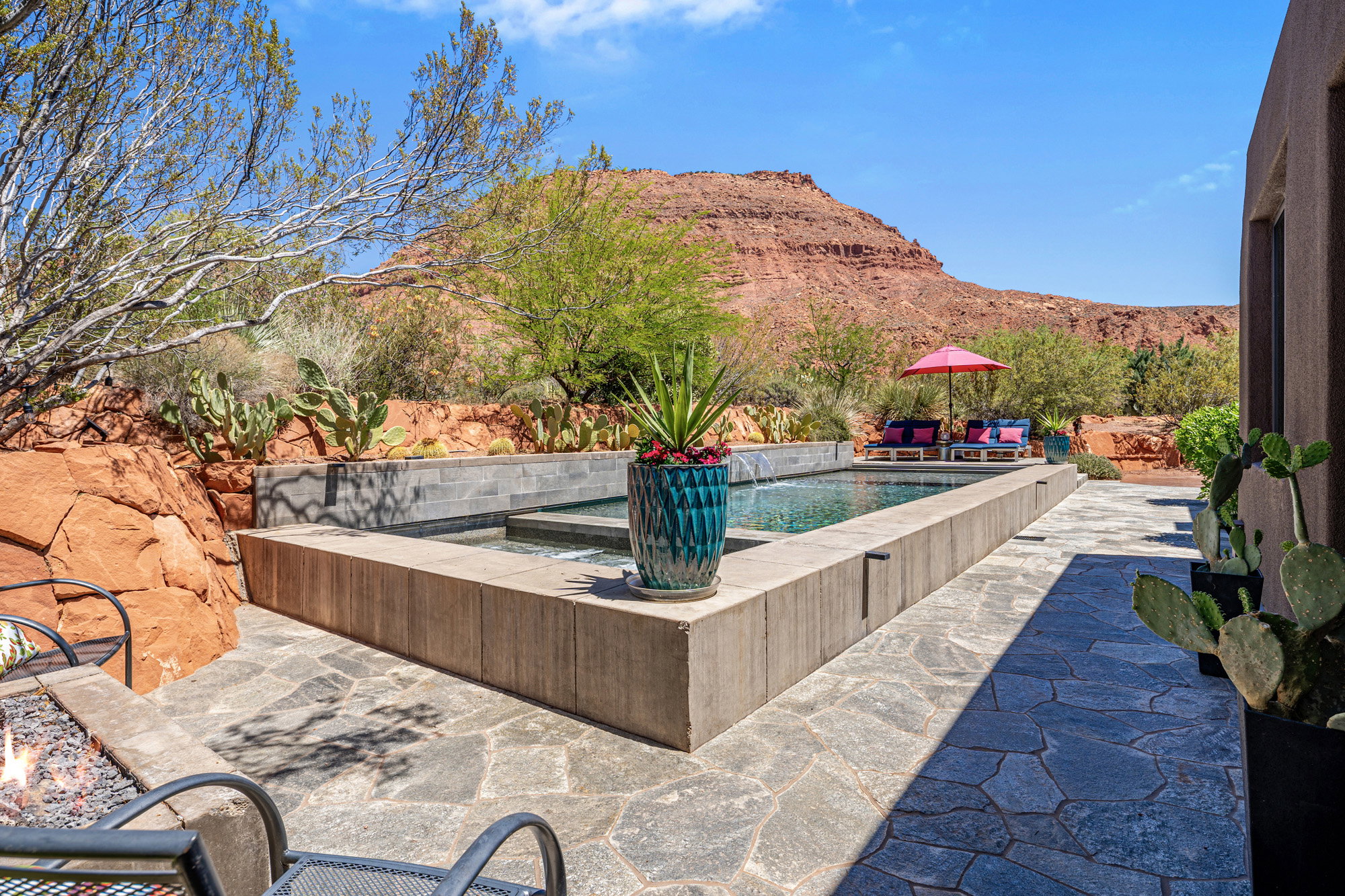 Outdoor living area featuring a rectangular pool and integrated spa