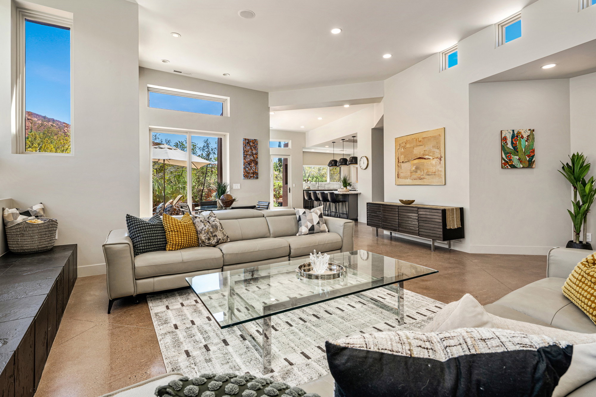 Spacious living area featuring high ceilings, recessed lighting, and large windows