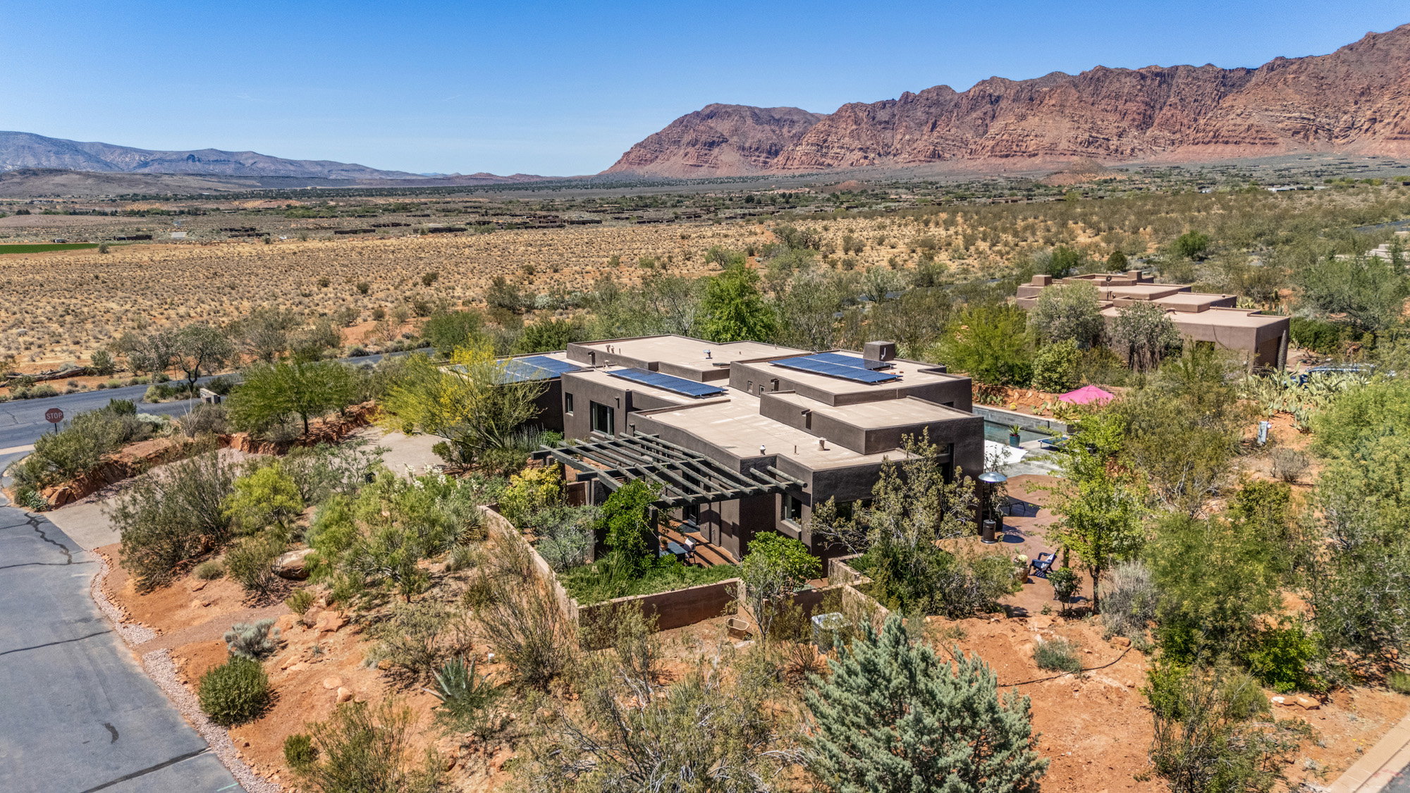 Modern architectural residence featuring a flat roofline and integrated solar panels