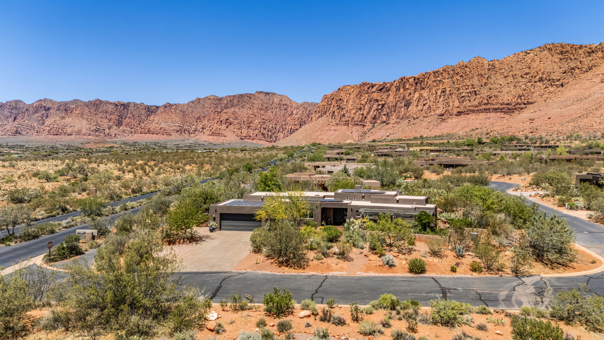 Desert landscape featuring a contemporary flat-roof residence