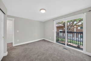Carpeted room with light grey walls and white trim
