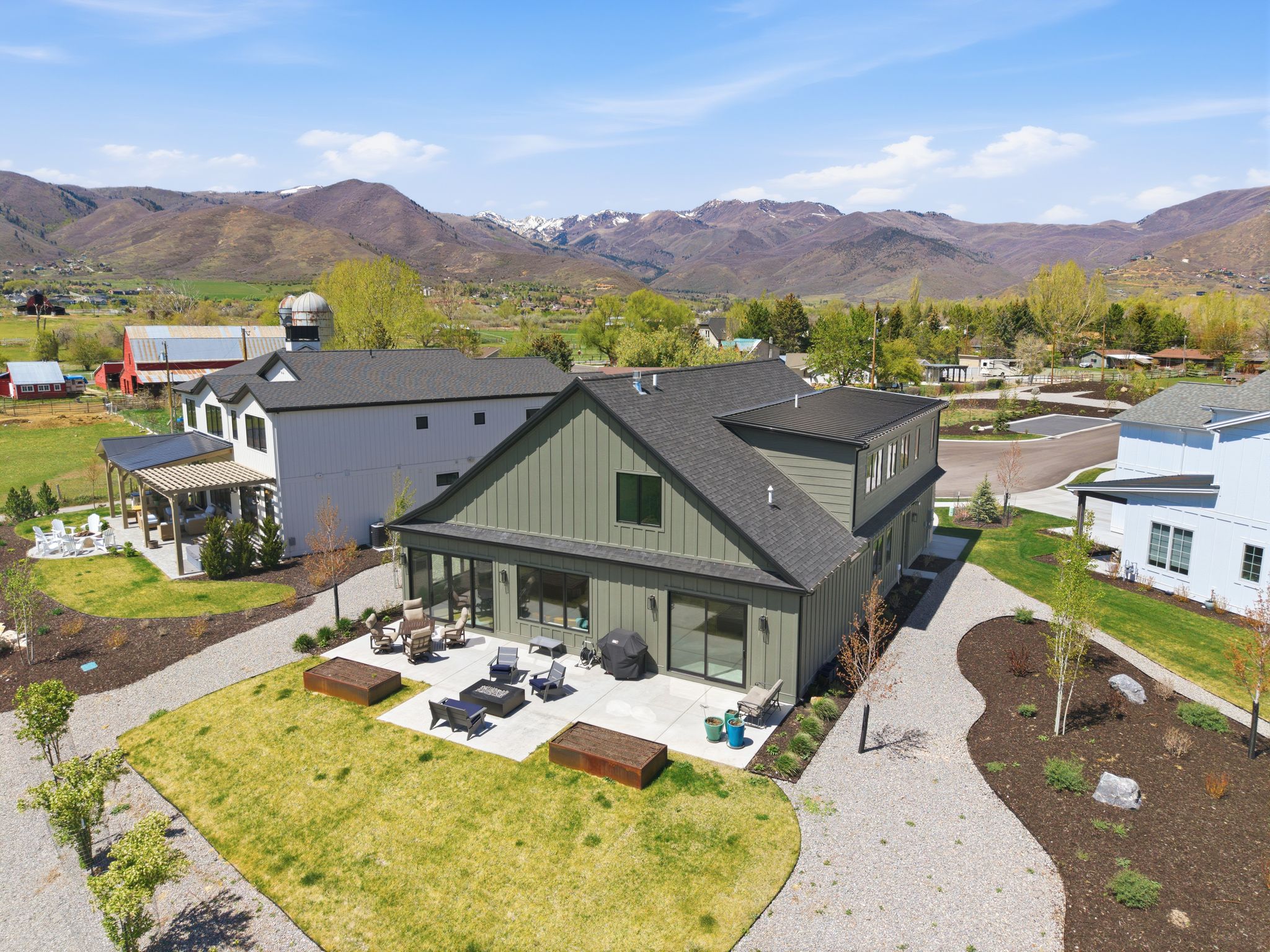 Modern-style exterior with olive green vertical siding and dark trim