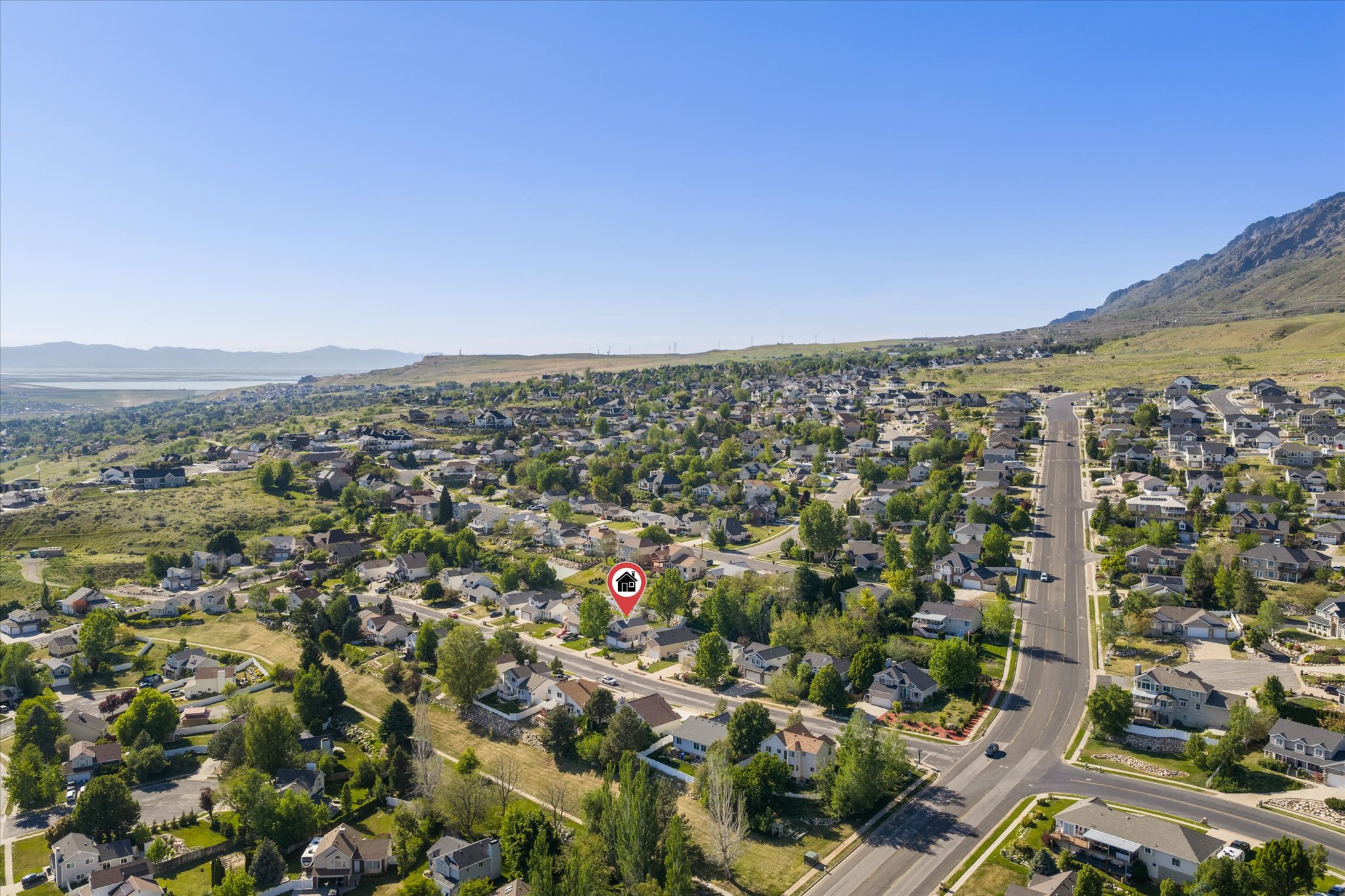 Aerial perspective showcasing a residential neighborhood with a mountain backdrop