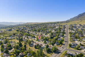 Aerial perspective showcasing a residential neighborhood with a mountain backdrop
