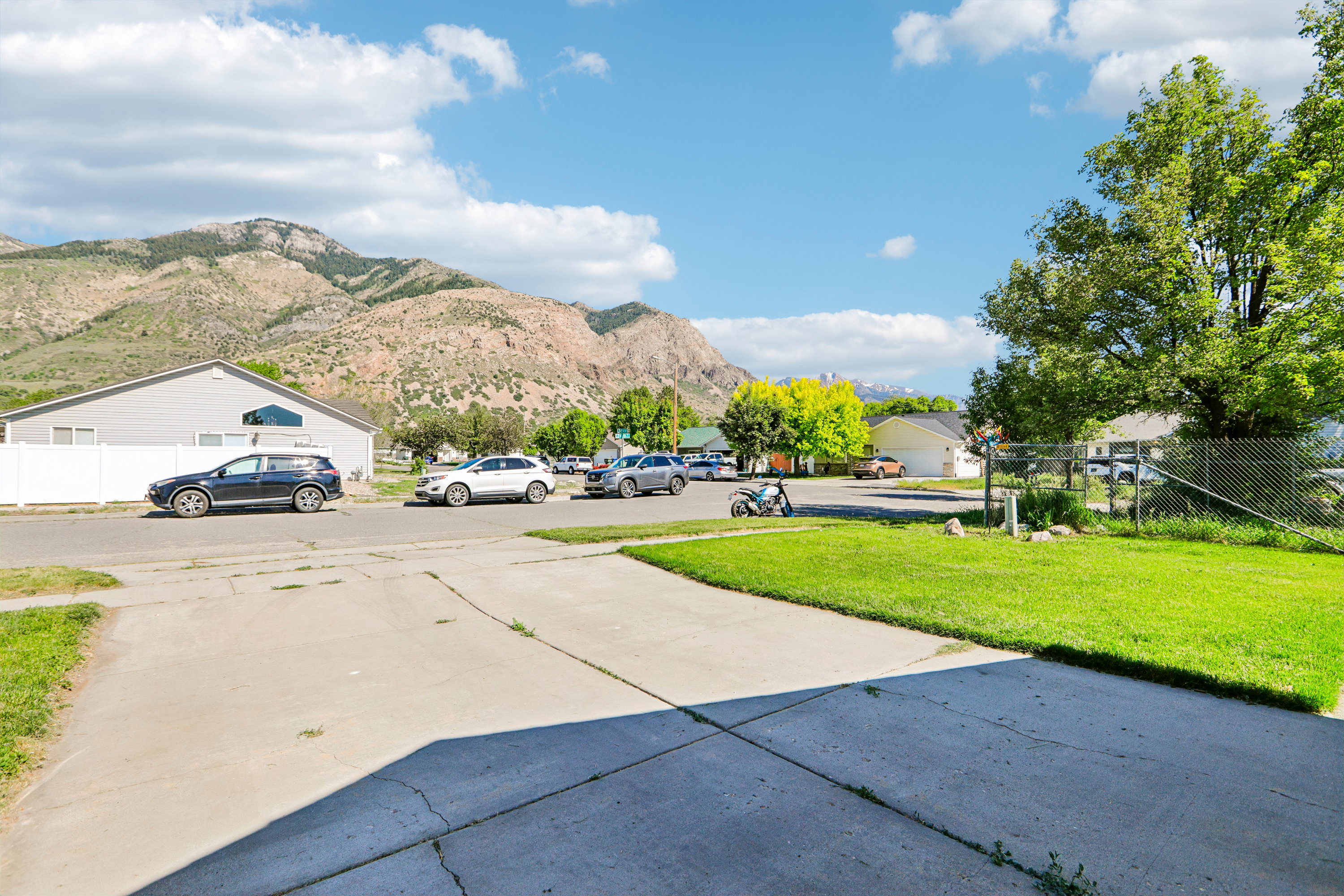 Concrete driveway with a manicured lawn area