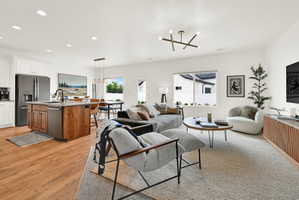 Expansive open-concept living space featuring wood-finish flooring, recessed lighting, and large windows