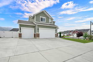 Two-story residence featuring green siding and white trim