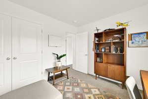 Neutral wall tones with carpeted flooring and white trim