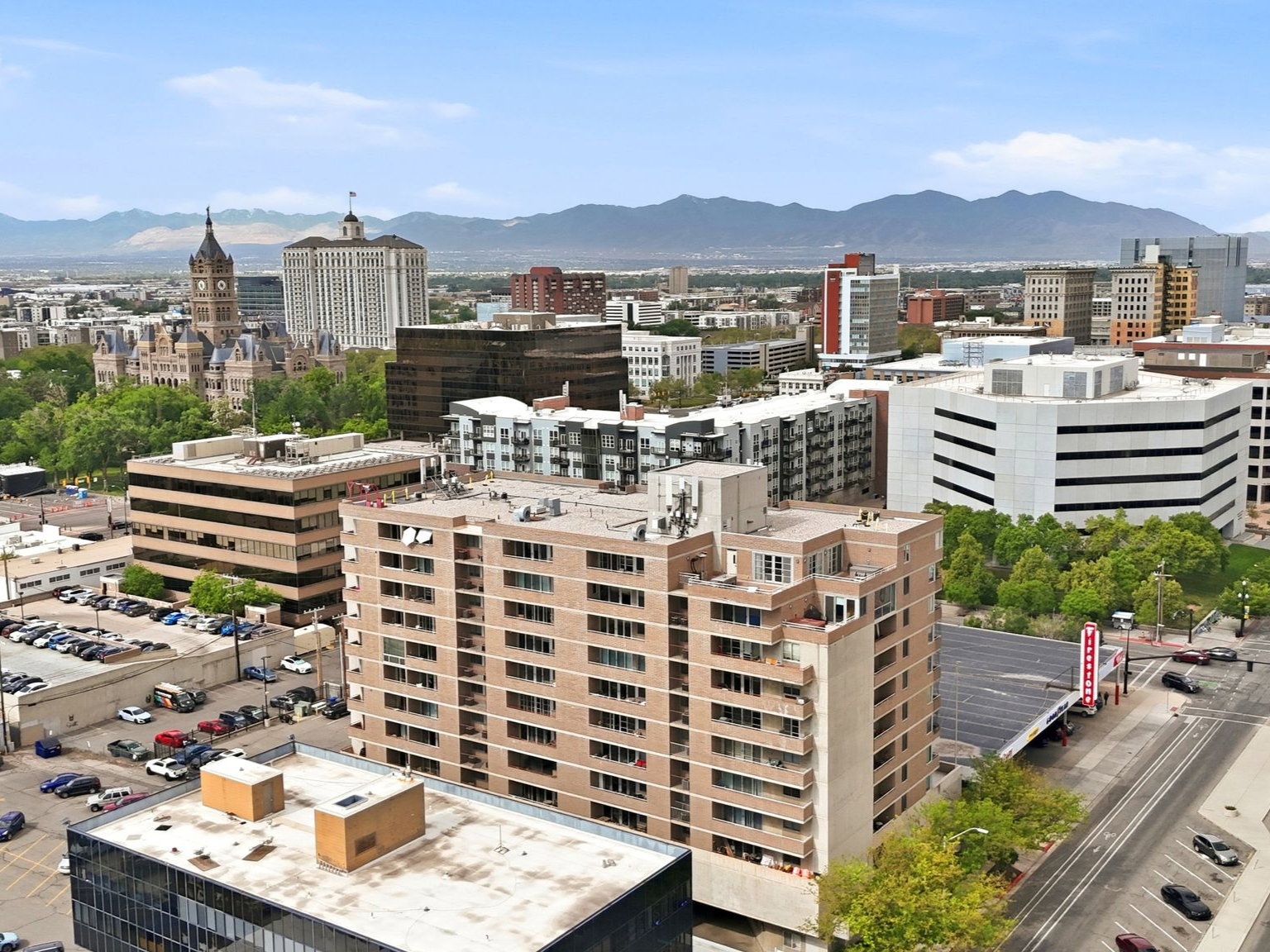 Urban landscape featuring diverse architectural styles, city streets, and distant mountains