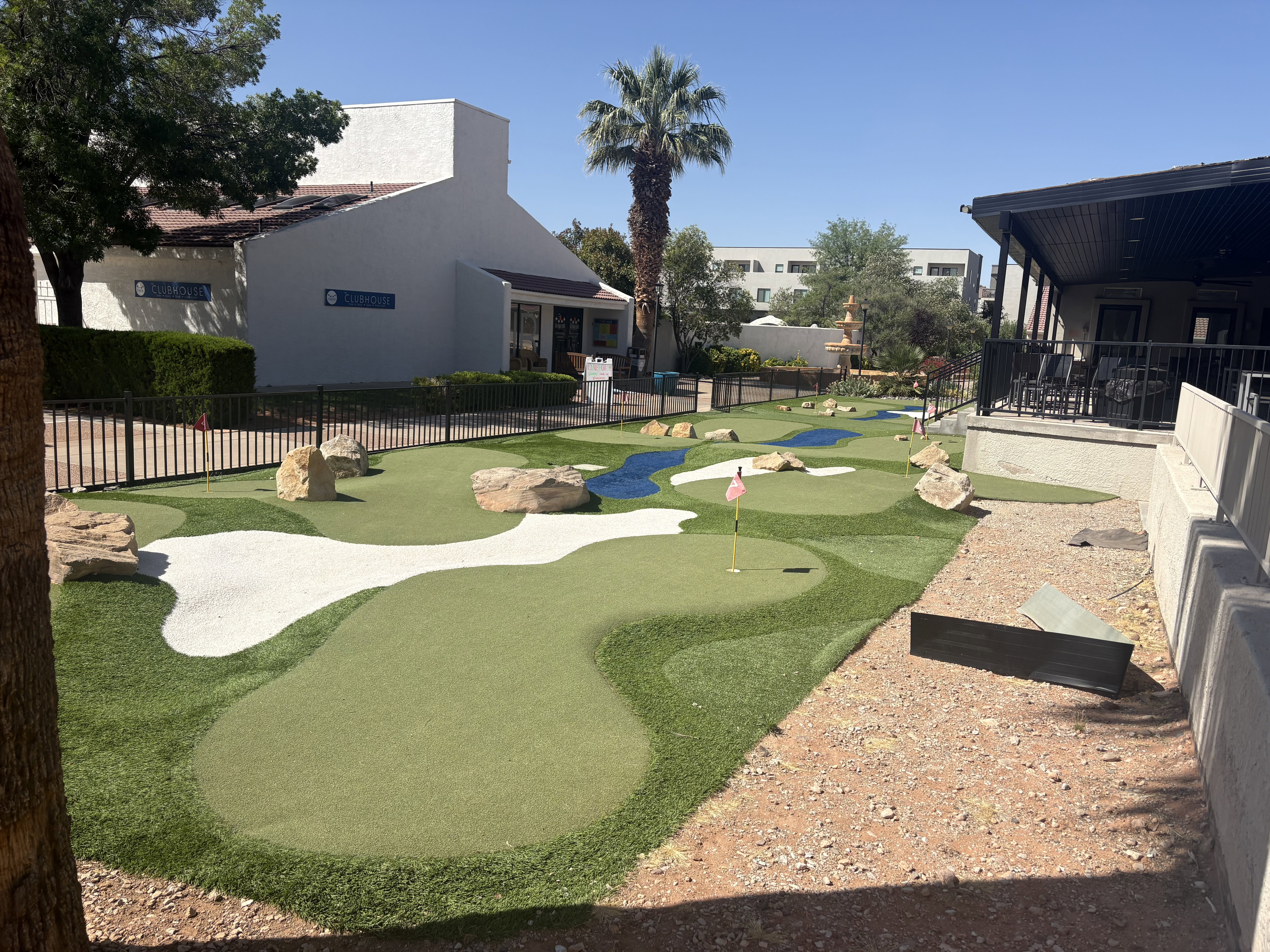 Outdoor putting green with multiple holes and bunkers