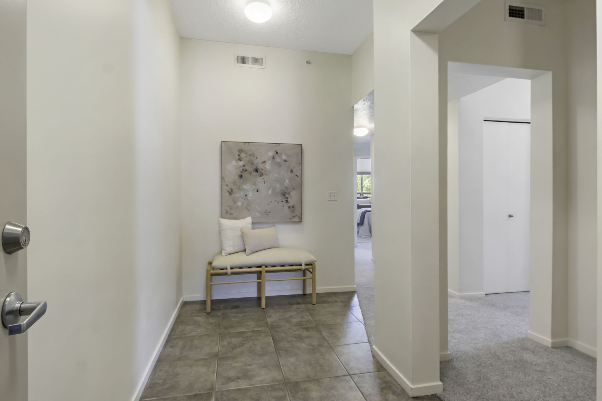 Entryway featuring neutral wall finishes, tile flooring, and flush-mount lighting