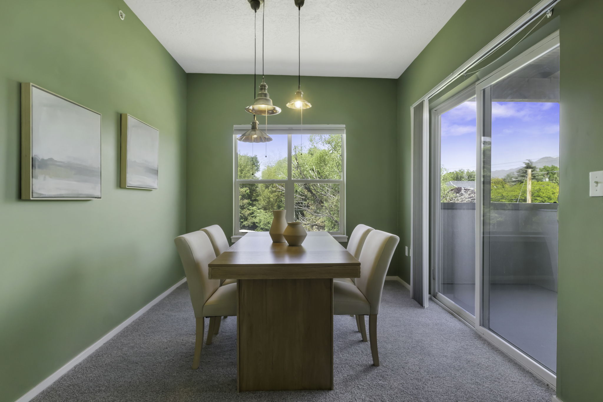 Dining area with a single pane window, glass sliding door, and pendant lighting fixtures