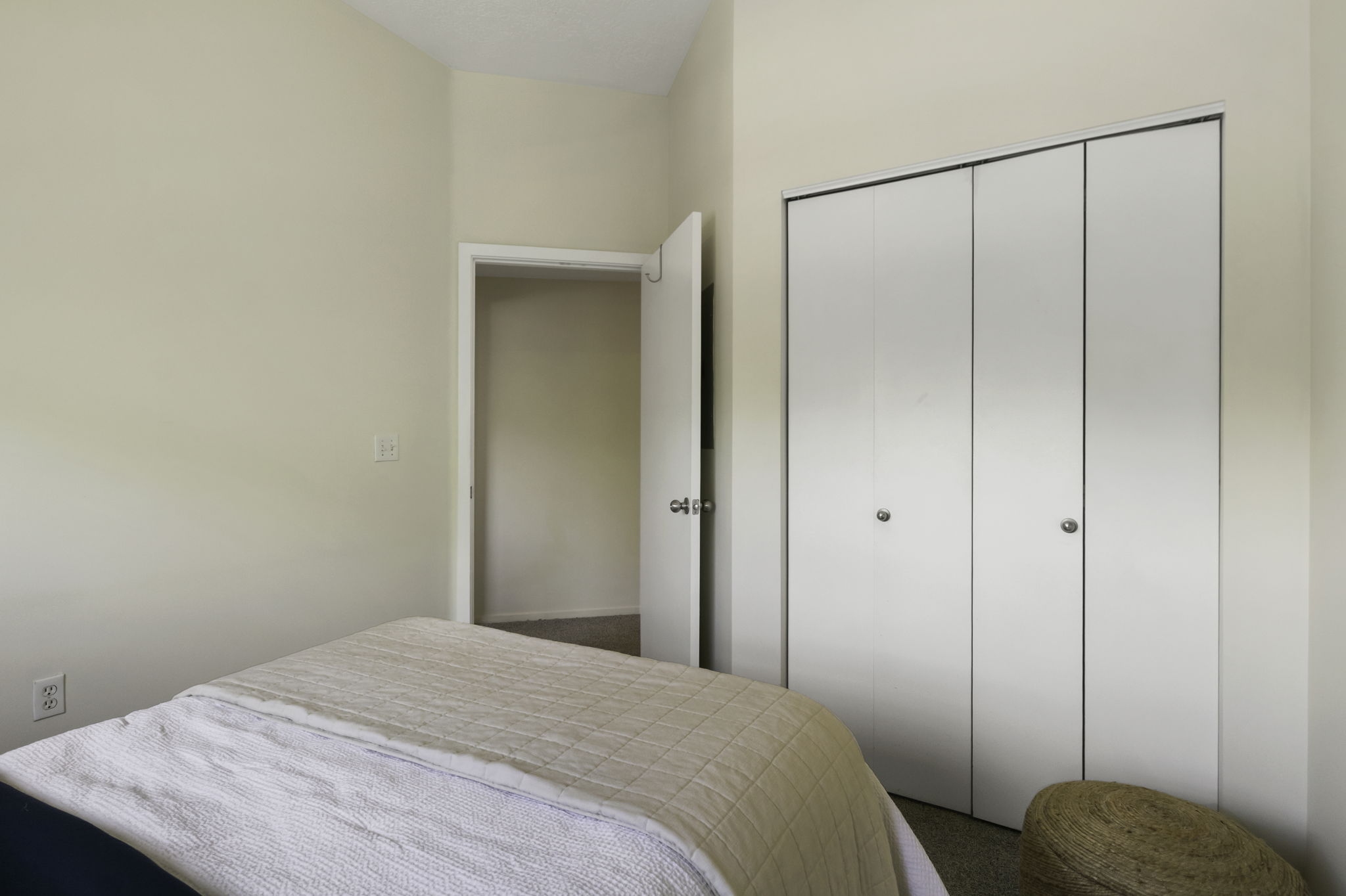 Neutral-toned walls and carpeted flooring define this space