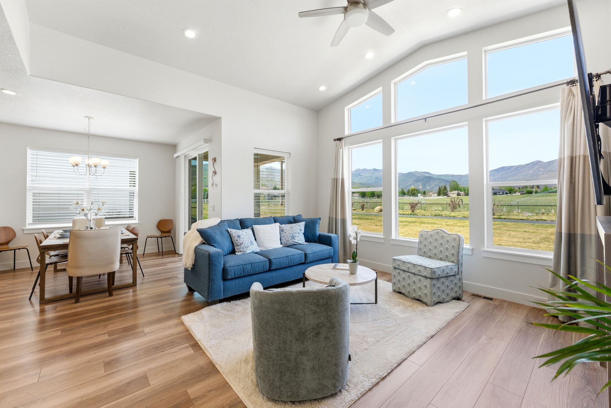 Living area featuring wood-finish flooring and a vaulted ceiling with recessed lighting