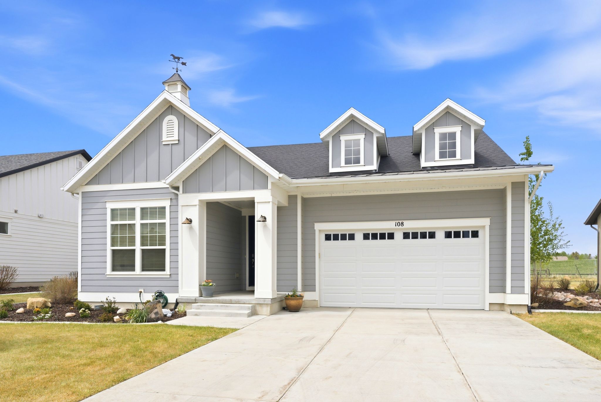 Contemporary gray siding exterior with white trim accents