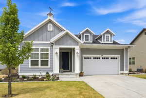 Contemporary single-story residence featuring light gray siding and white trim