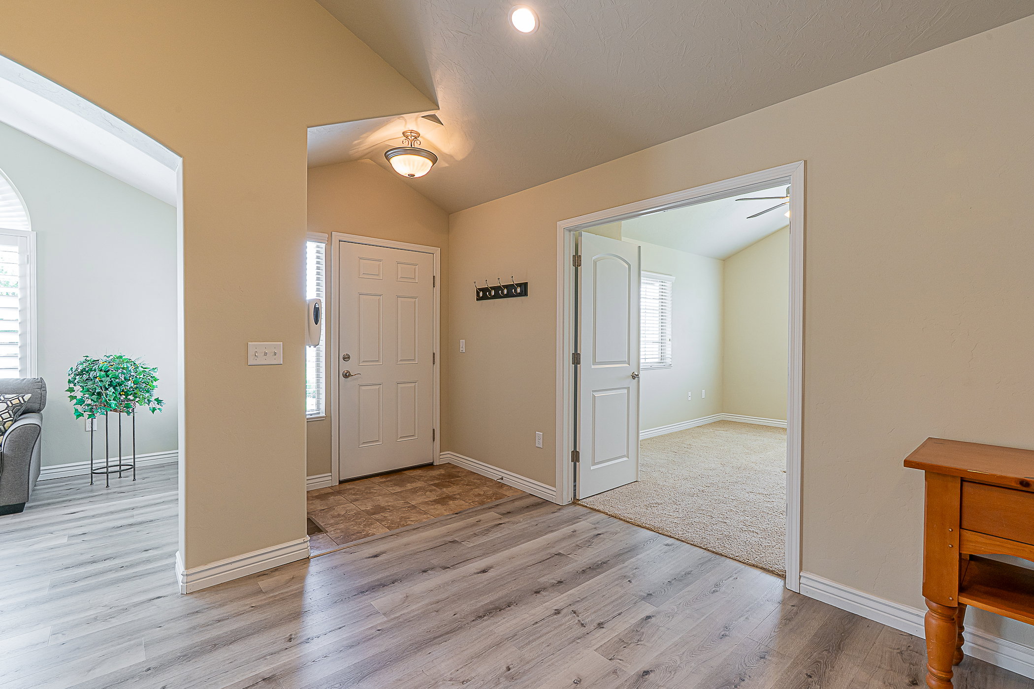 Entryway featuring wood-finish flooring, a neutral color palette, and a paneled entry door