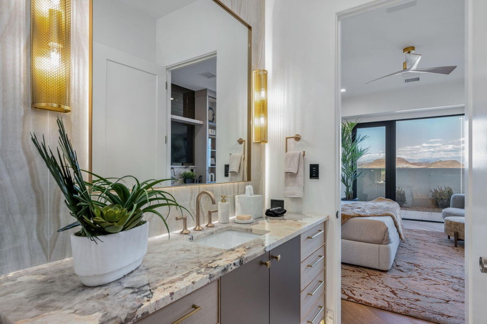 Contemporary vanity with a polished stone countertop and integrated sink