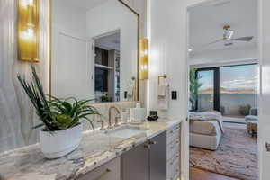 Contemporary vanity with a polished stone countertop and integrated sink