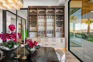 Built-in bar with extensive wine storage, integrated stemware racks, and a light-toned countertop