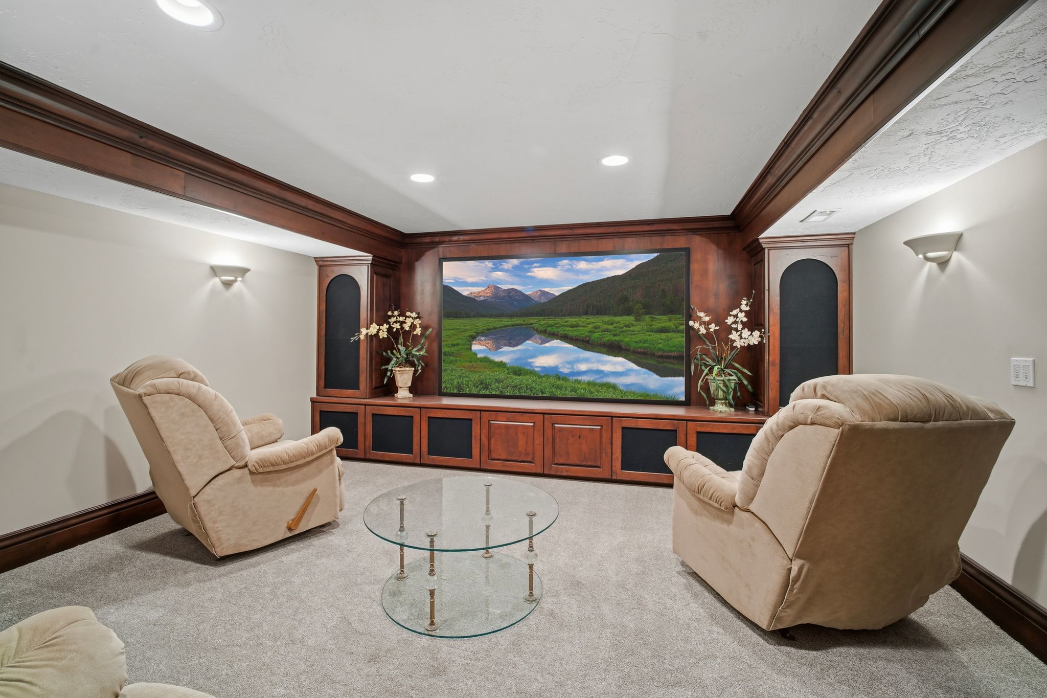 Entertainment room featuring a built-in media center with wood-finish cabinetry and integrated speakers