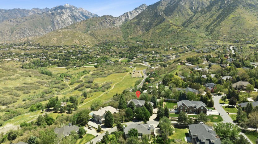 Mountainous terrain surrounding a residential area with varied housing styles