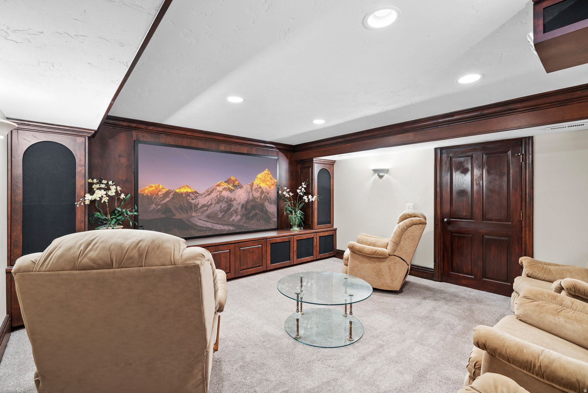 Entertainment space featuring a large built-in media console with integrated shelving and display areas