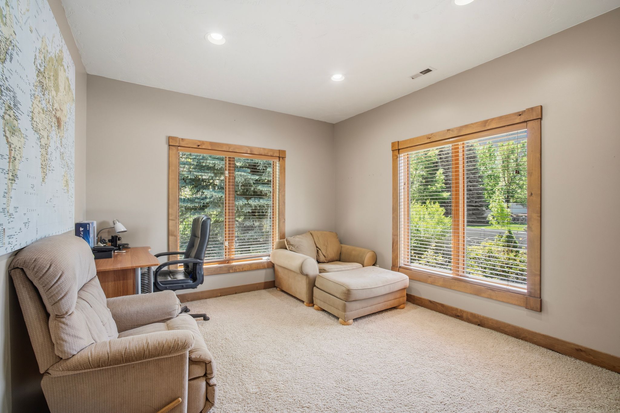 Neutral wall tones complement the wood-trimmed windows