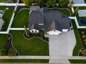 Expansive property featuring a multi-gabled roofline, concrete driveway, and front-facing garage doors
