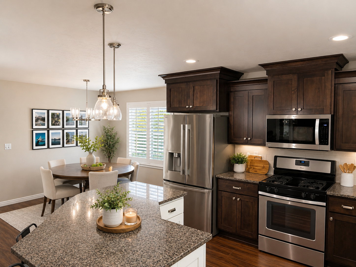 Kitchen and dining area featuring dark wood-finish cabinetry, stainless steel appliances, and wood-finish flooring