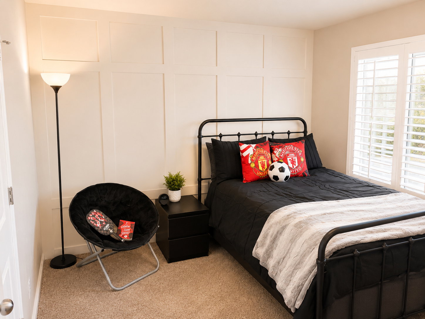 Bedroom featuring a decorative board and batten wall accent