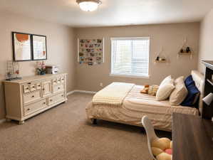 Carpeted room with a ceiling light fixture, a window with blinds, and light neutral wall paint