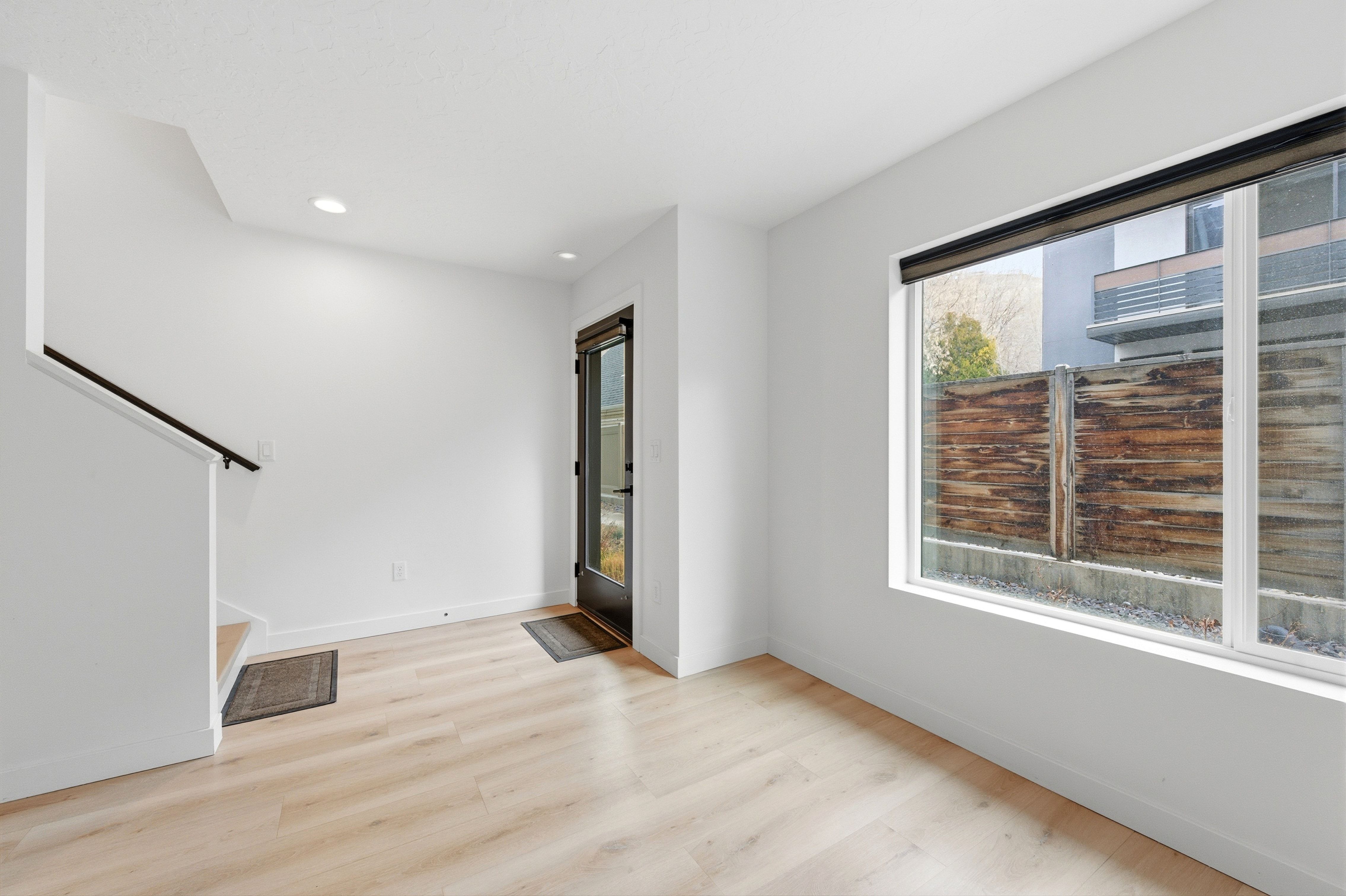 Bright interior space featuring light wood-finish flooring and a large window