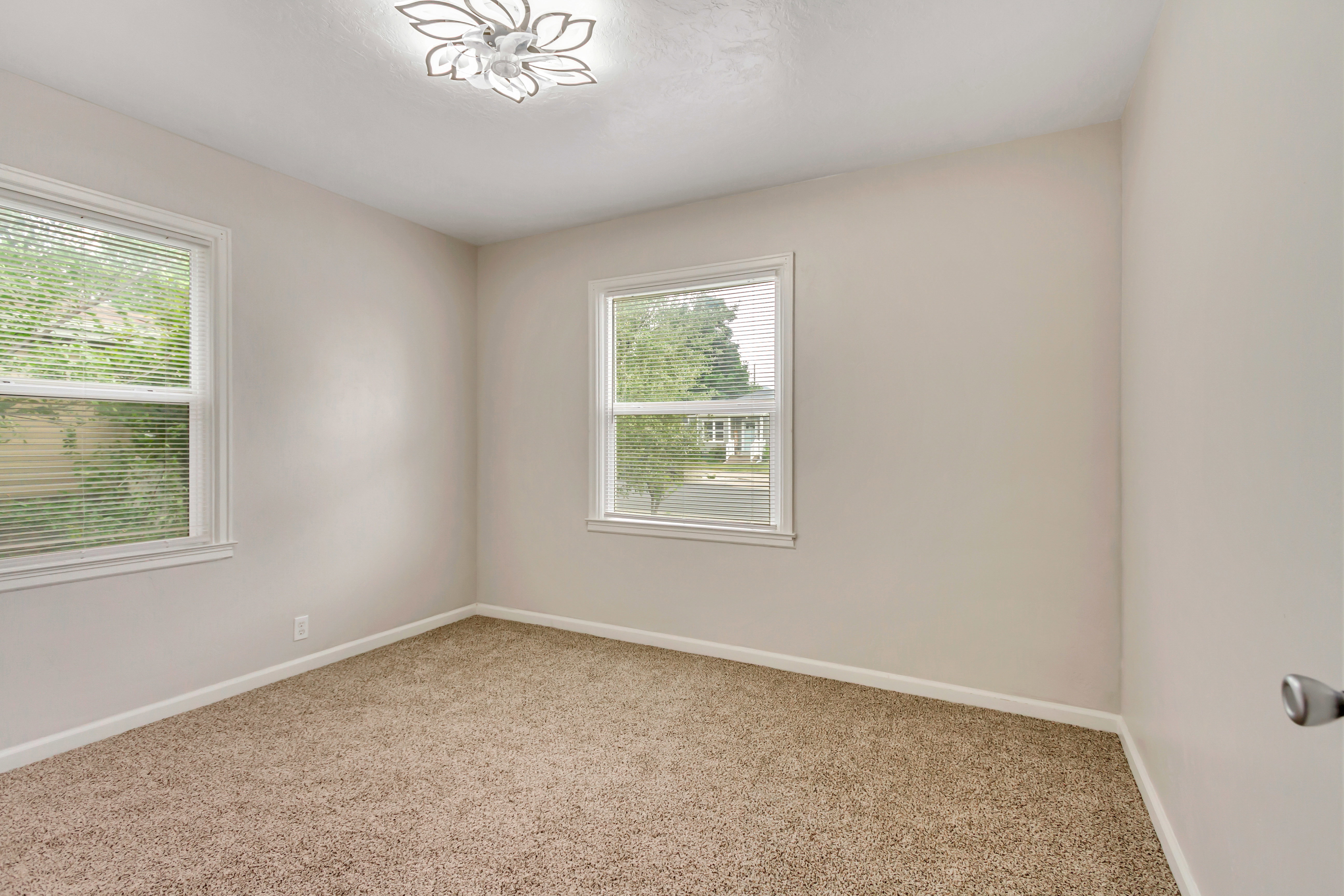Neutral tone walls with textured carpeting throughout