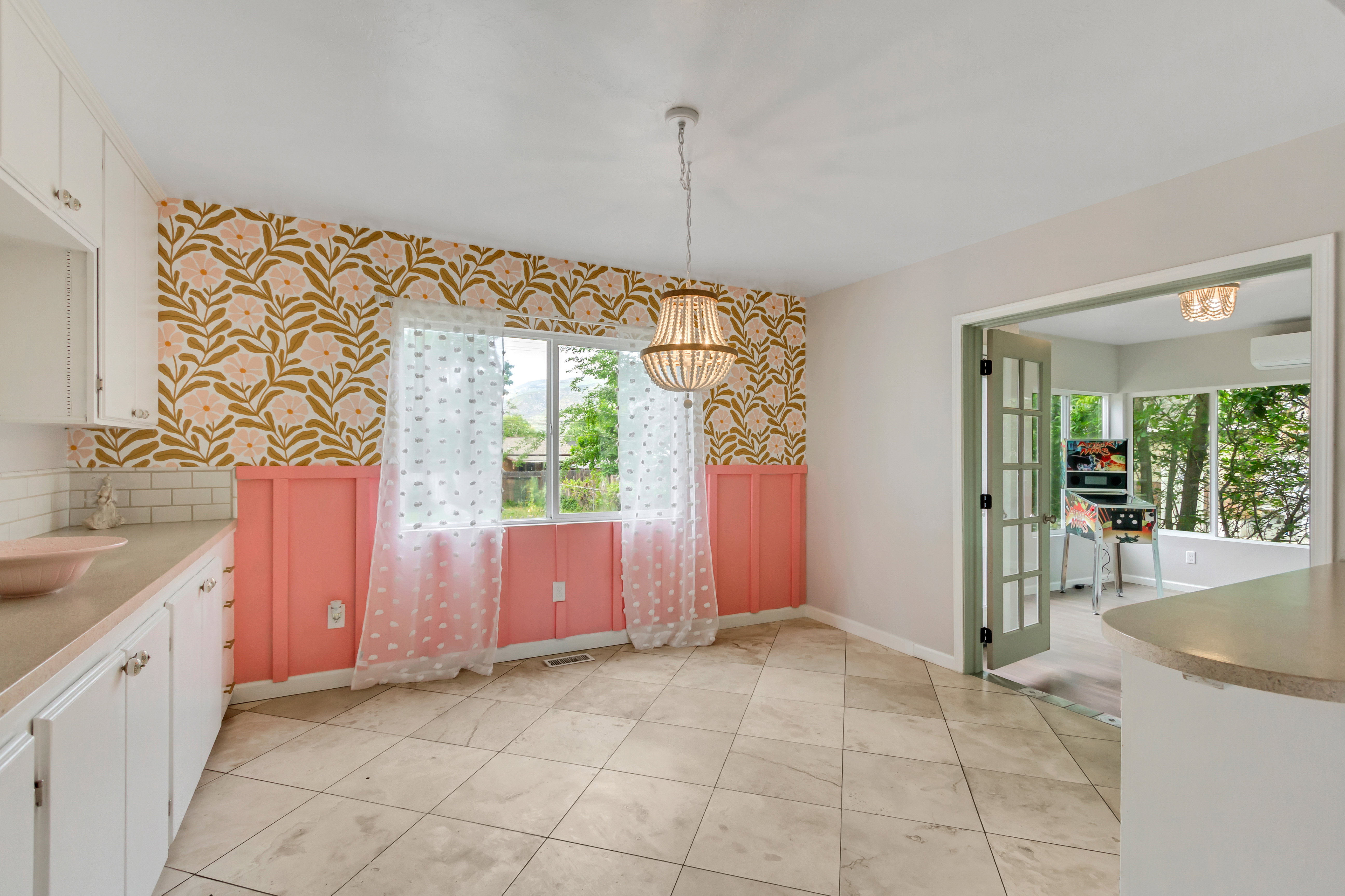 Dining area featuring patterned wallpaper and decorative wainscoting