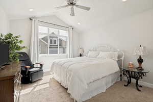 Bedroom featuring vaulted ceilings, recessed lighting, and a multi-pane window