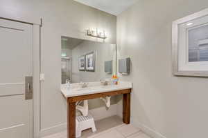 Dual-sink vanity with a light-toned countertop, set on a wood-finish base
