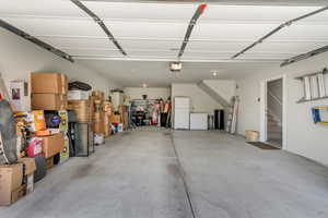 Spacious garage featuring a concrete floor, painted walls, and an overhead garage door mechanism