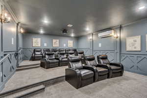 Dedicated theater room featuring tiered seating on carpeted platforms