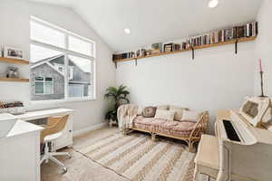 Vaulted ceiling room with an expansive multi-pane window, recessed lighting, and built-in floating shelving