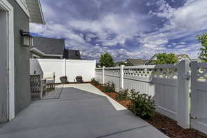 Spacious concrete patio with a full privacy fence