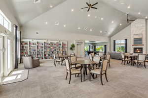 Spacious common area featuring vaulted ceilings, recessed lighting, and patterned carpet flooring