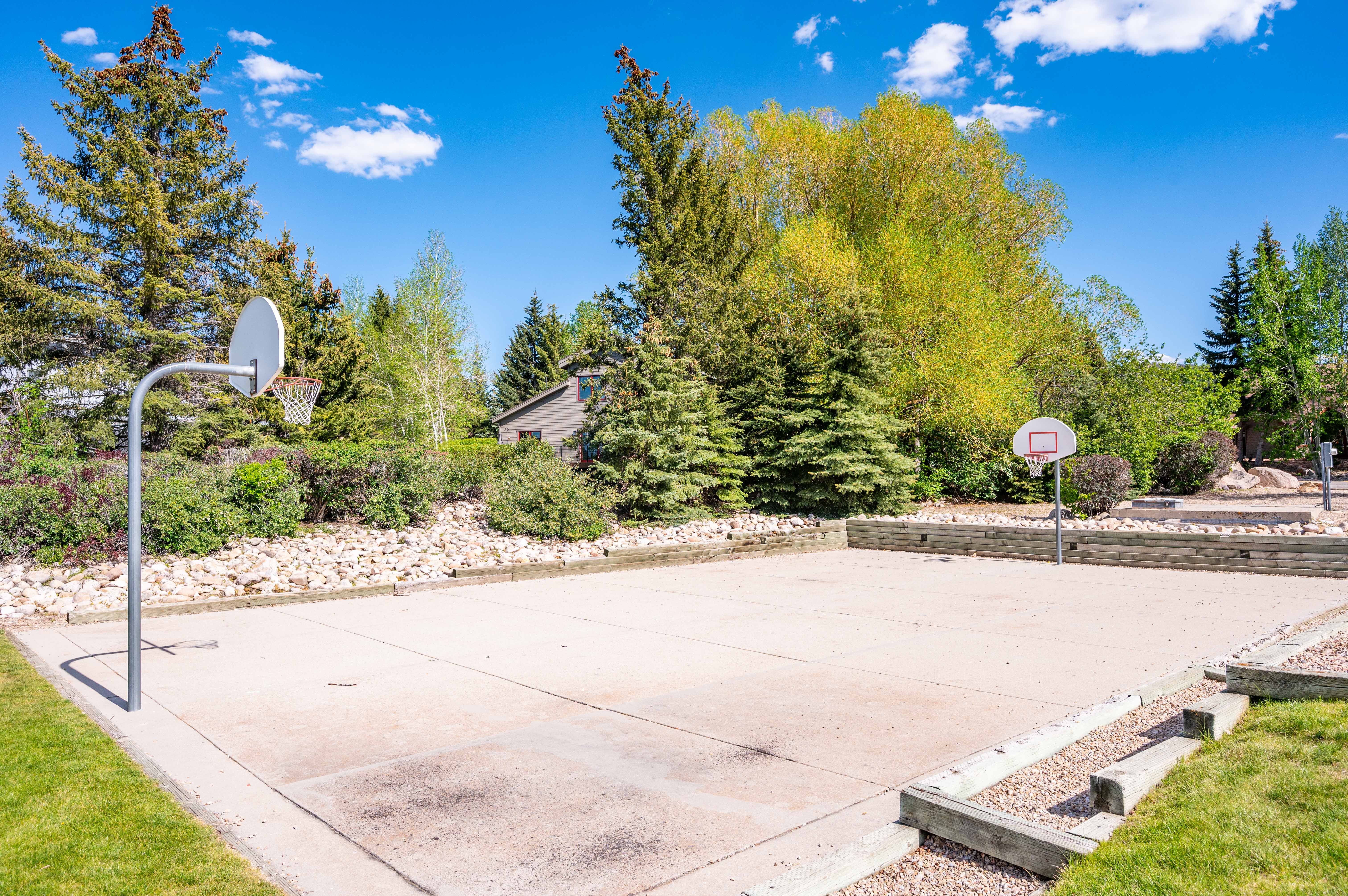 Concrete sports court with two basketball hoops