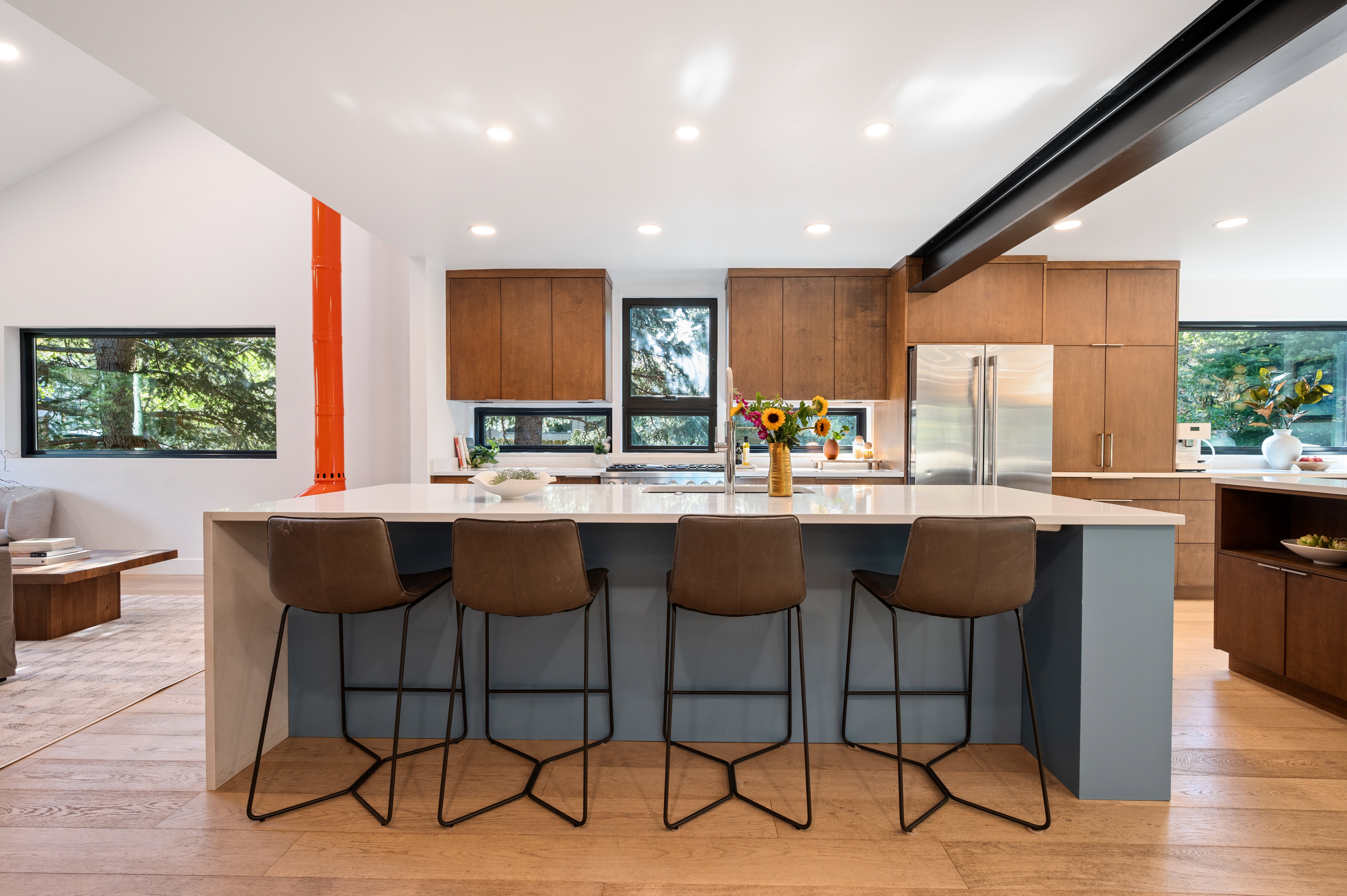 Kitchen island with a light-toned countertop and integrated seating