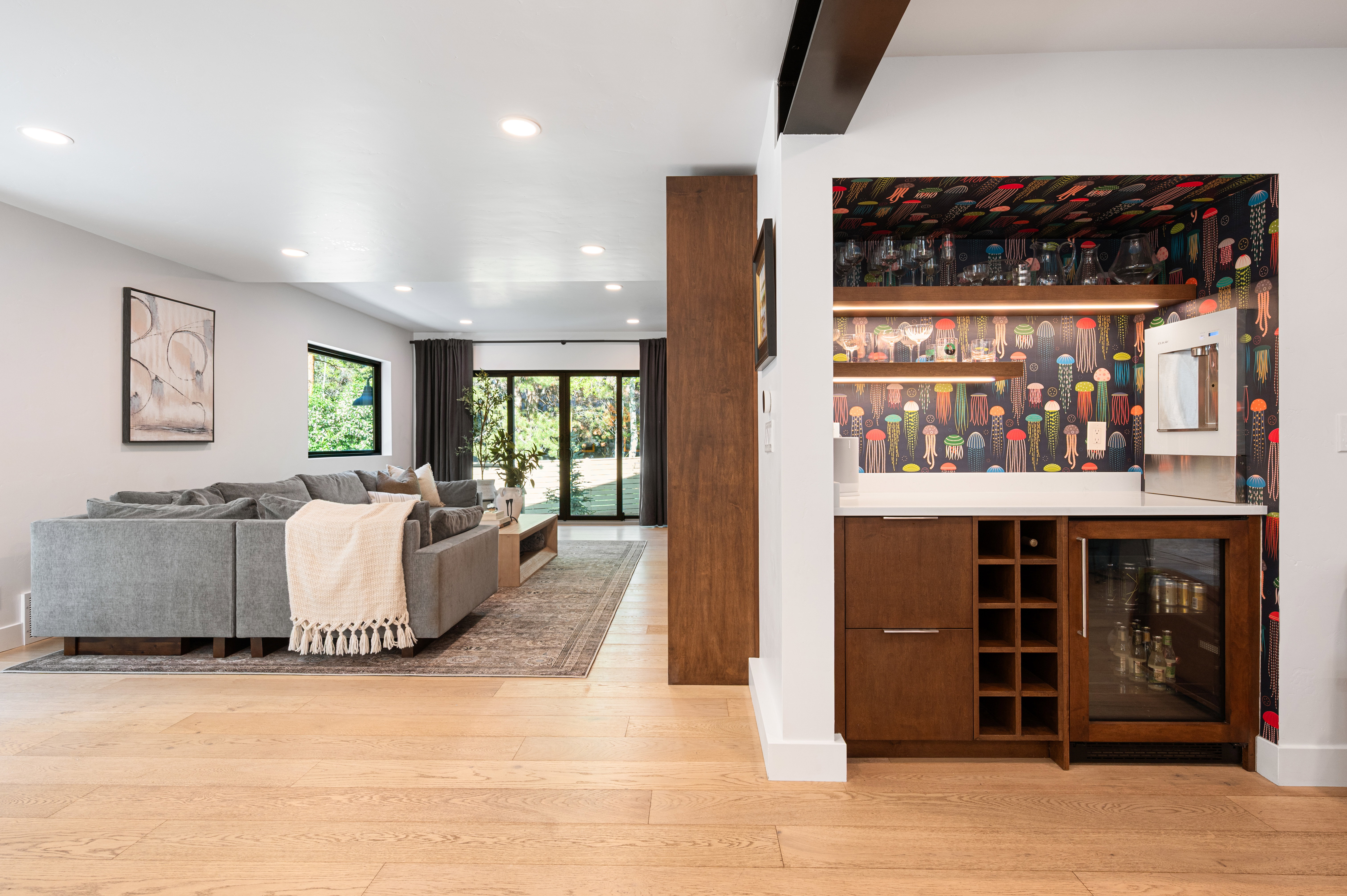 Built-in wet bar featuring wood-finish cabinetry, a wine rack, and a beverage cooler