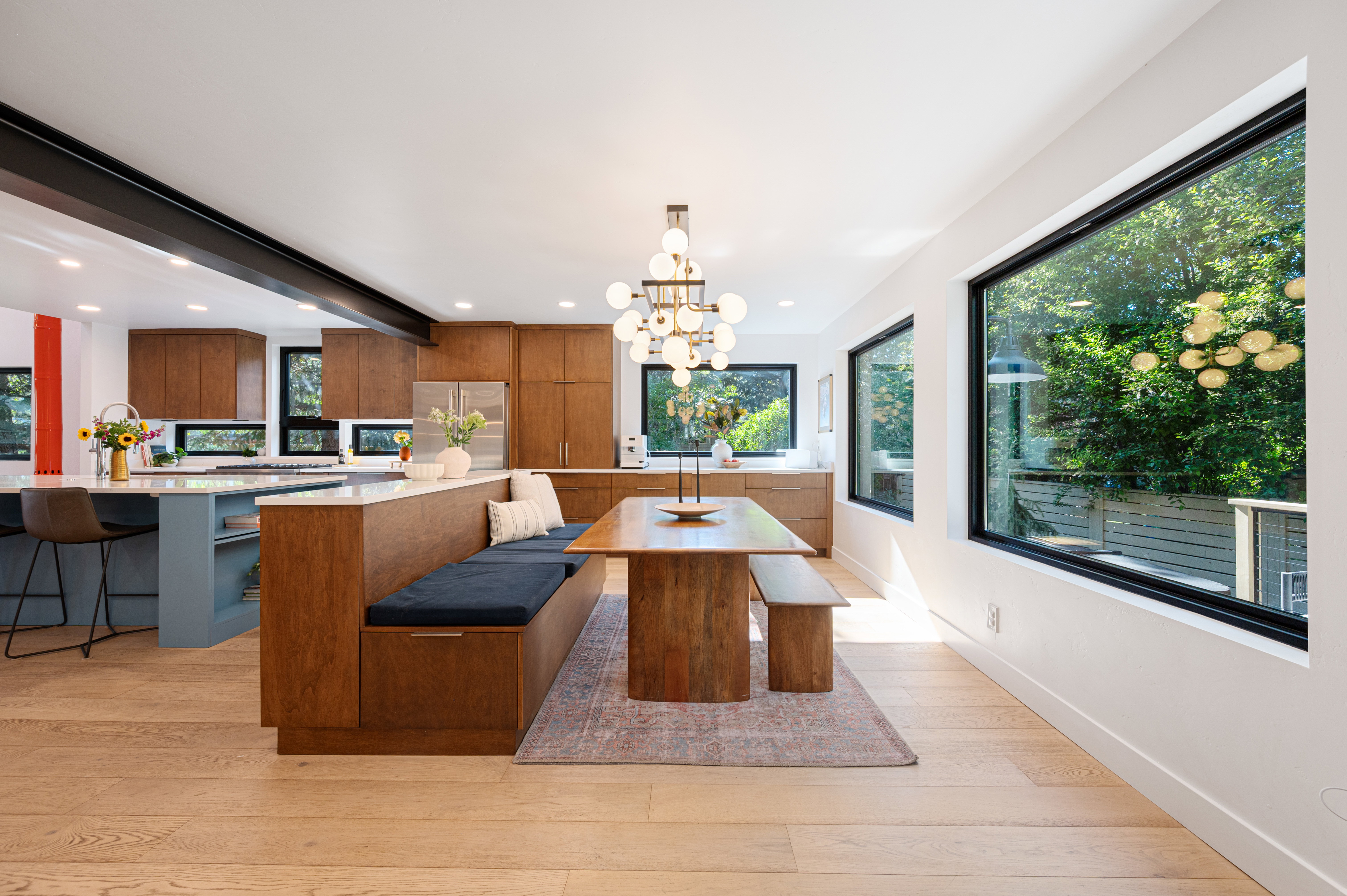 Open-concept kitchen and dining area featuring light wood-finish flooring