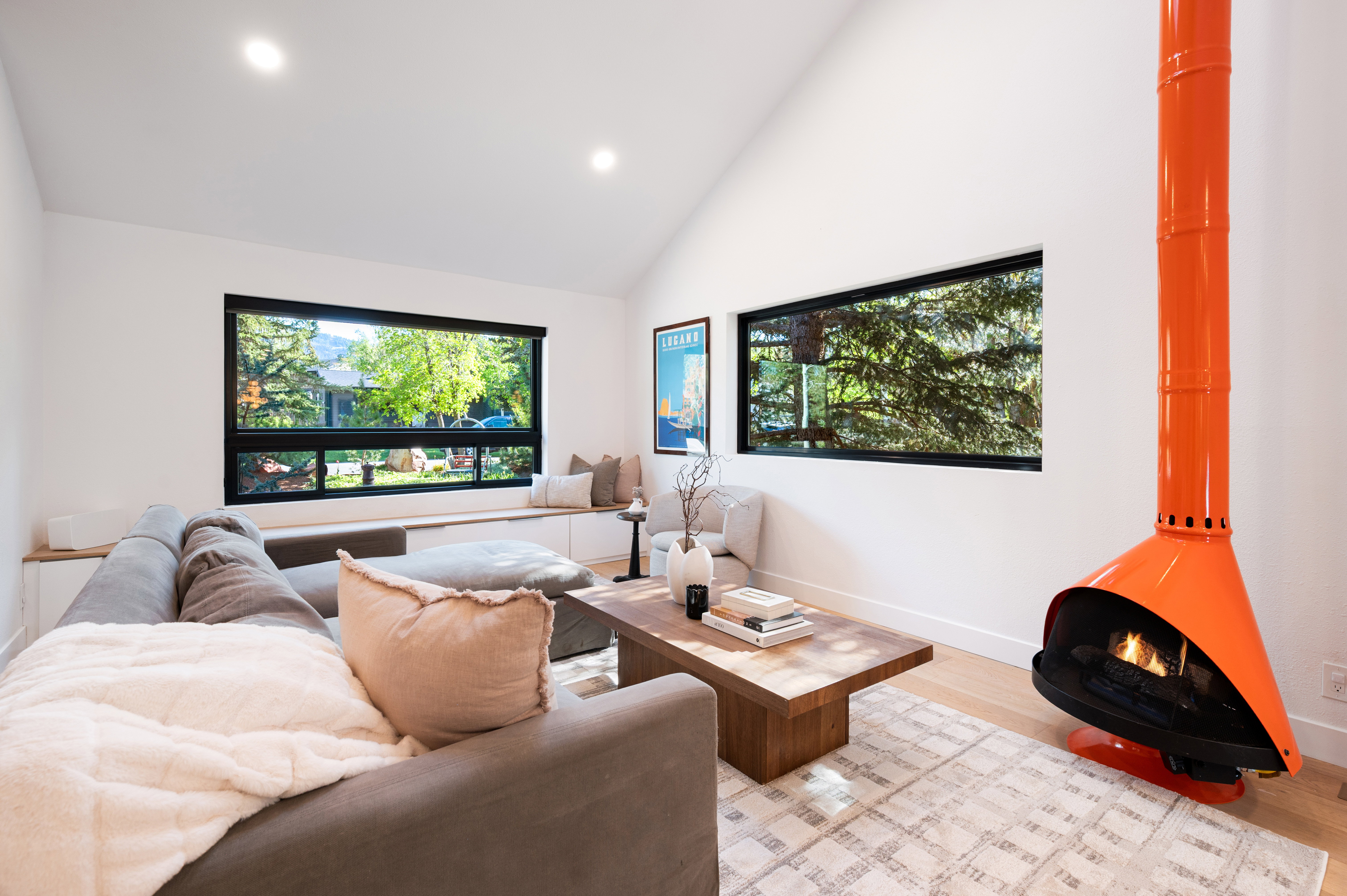 Living area featuring a vaulted ceiling and light wood-finish flooring