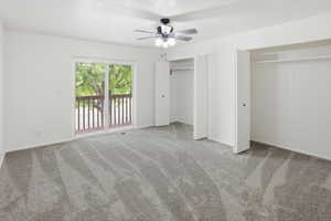 Spacious room featuring neutral carpeting and white walls