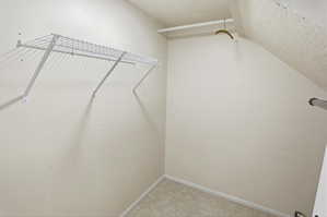 Walk-in closet with wire shelving and a hanging rod