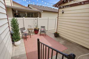 Concrete patio space featuring a privacy fence and exterior siding